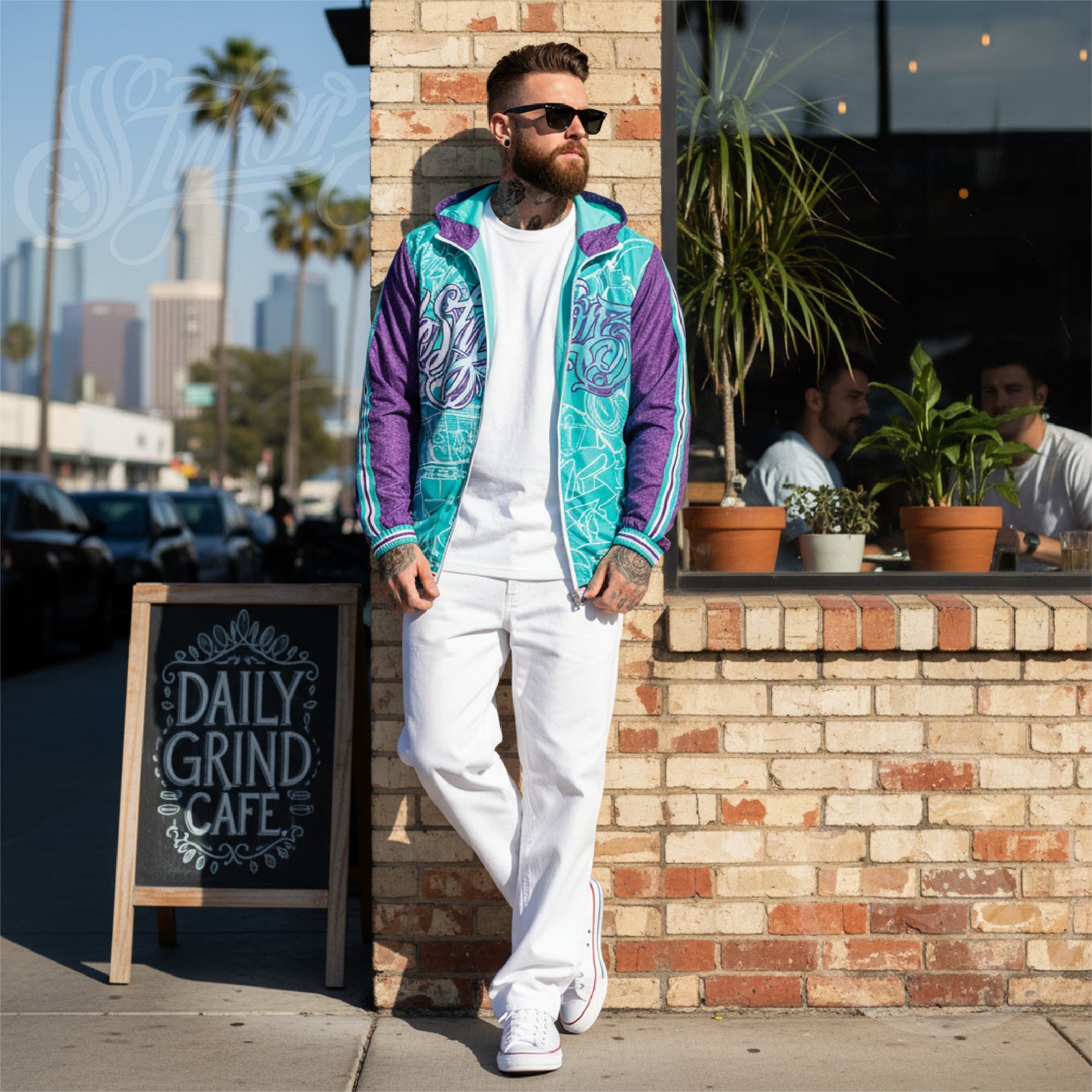 Man in colorful jacket and white pants standing in front of a cafe with a cityscape background